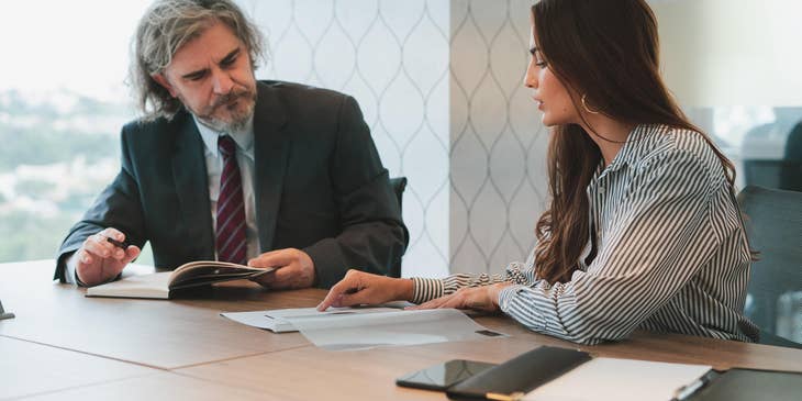 AN HR officer is answering an employee's 401(k) questions.