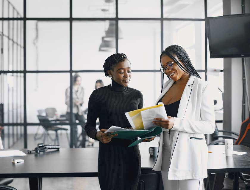 Two office workers discussing employee benefits.