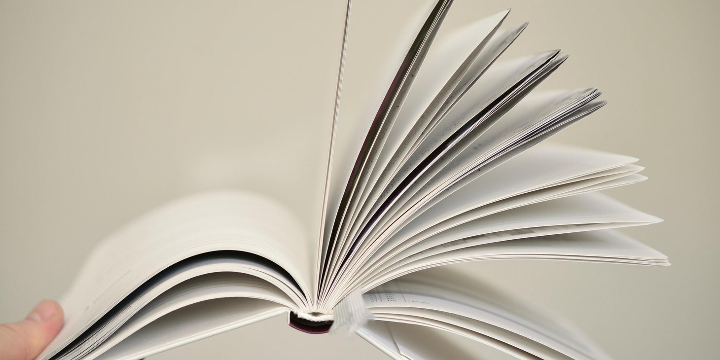 Handbook being held against a white background