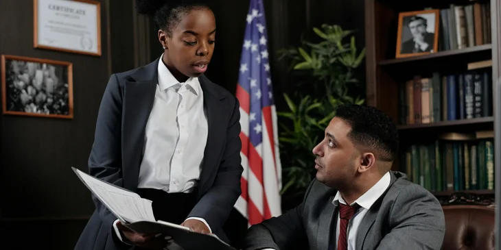 An employer handing an employee a termination letter.