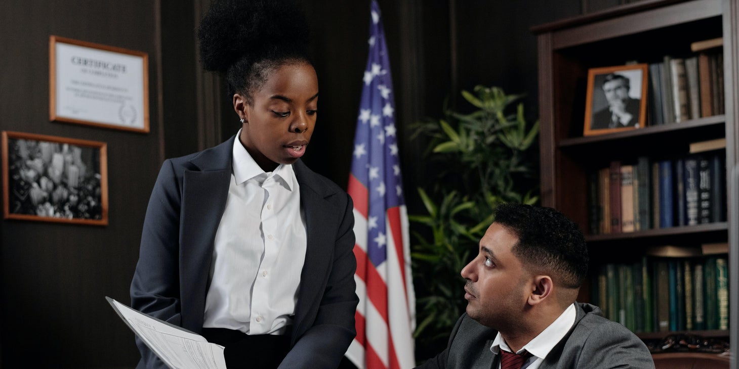 Employer handing an employee a termination letter.