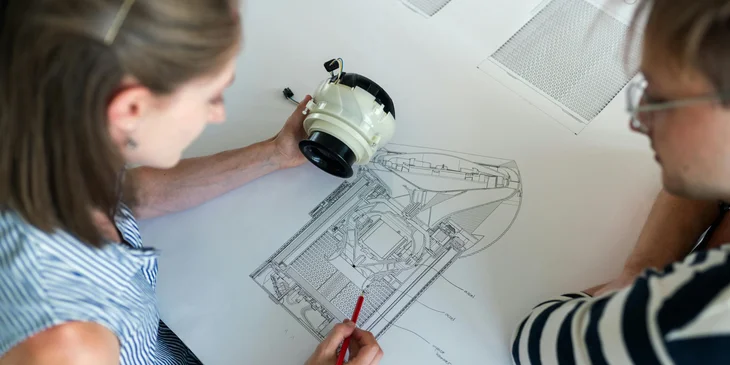 Two engineers working on a design.