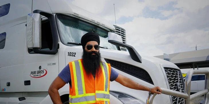 A man standing by a truck.