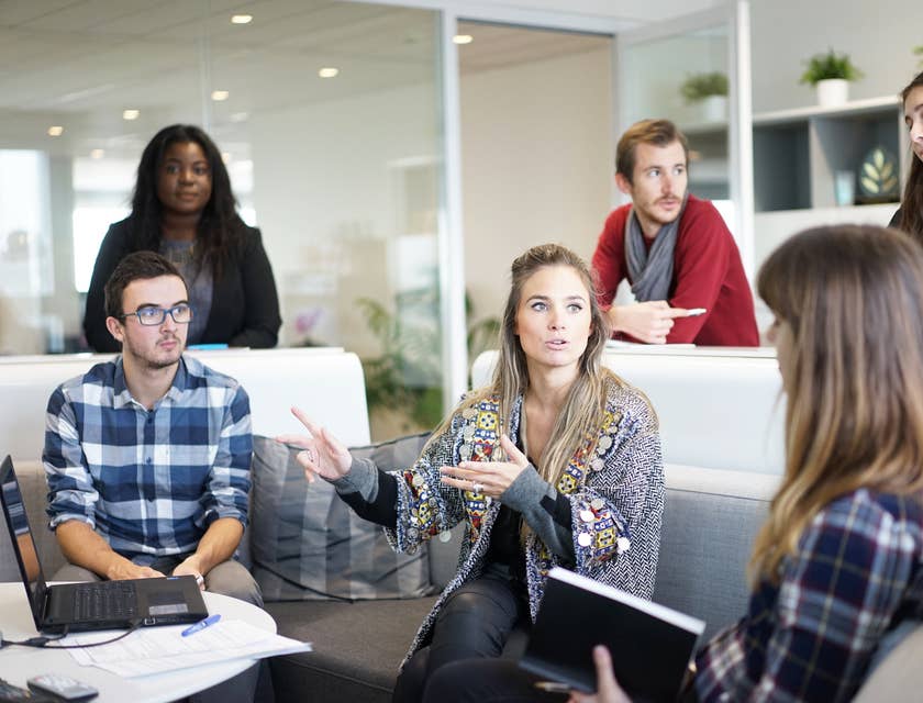 A group of colleagues discussing work in an office space.