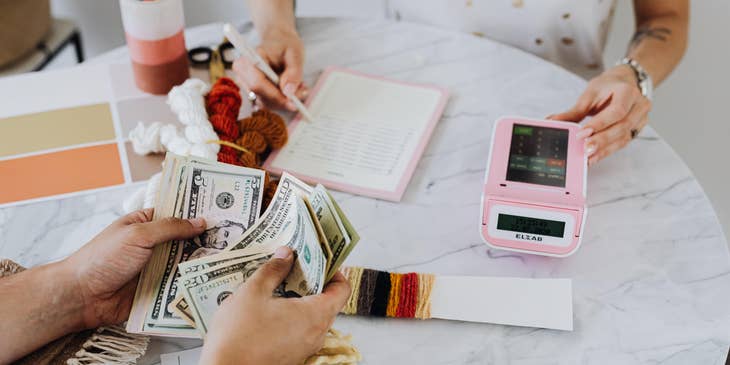 Two coworkers handling money