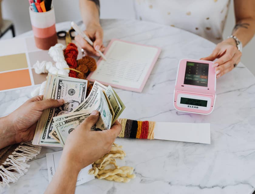 Two coworkers handling money