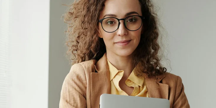 A woman holding a laptop.