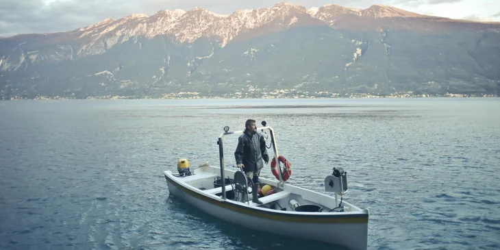 A man fishing from a boat.