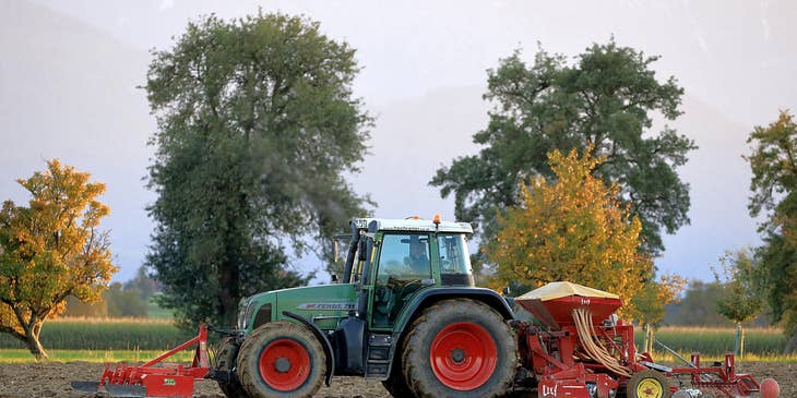 A farm with a tractor and other farming equipment.