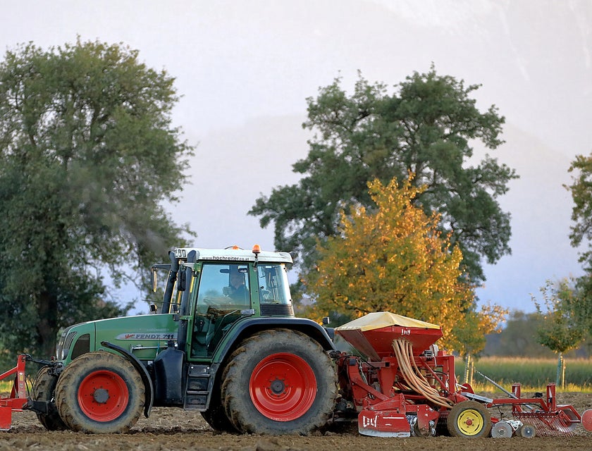 A farm with a tractor and other farming equipment.