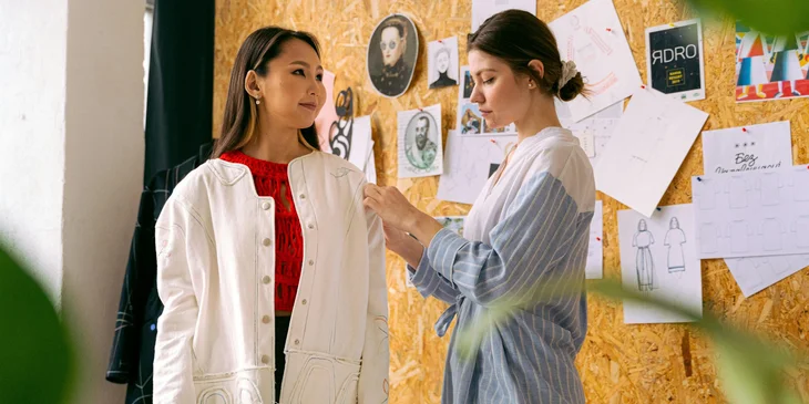 A fashion consultant working with a client on their wardrobe.