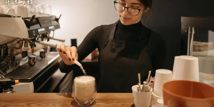 An employee making coffee.