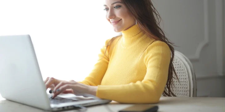 A woman working on her laptop.