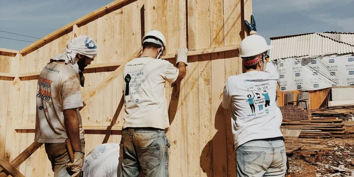Fence installers setting up the fence in position to serve as a barrier.