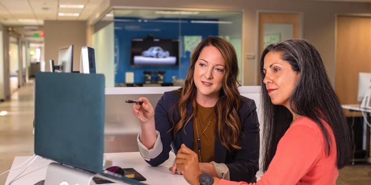 A financial admin assistant discussing the cost of an item with a co-worker.