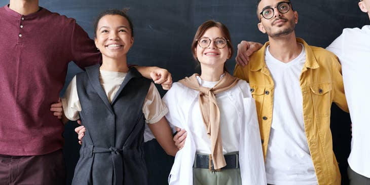 Employees smiling while taking a group photo.