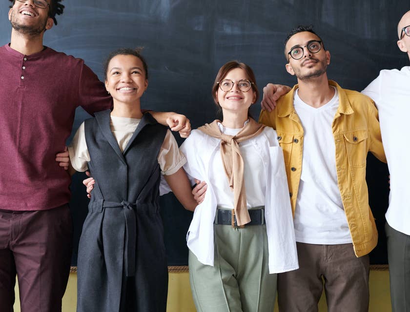Employees smiling while taking a group photo.