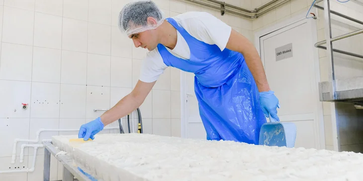 A man working in a cheese factory.