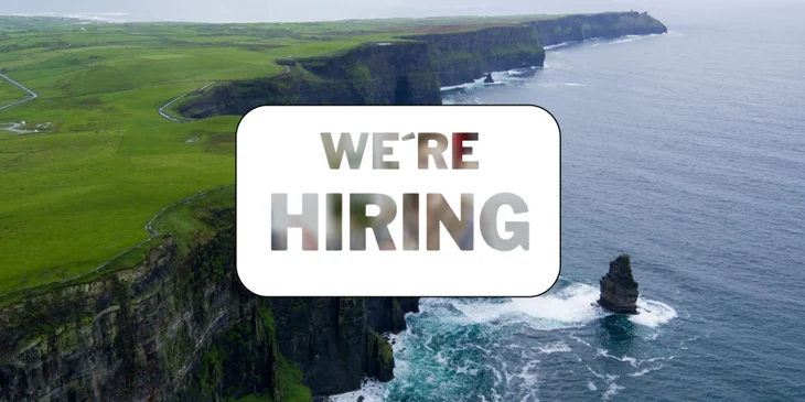 A sign reading "We're Hiring" placed in front of a well-known local landmark.
