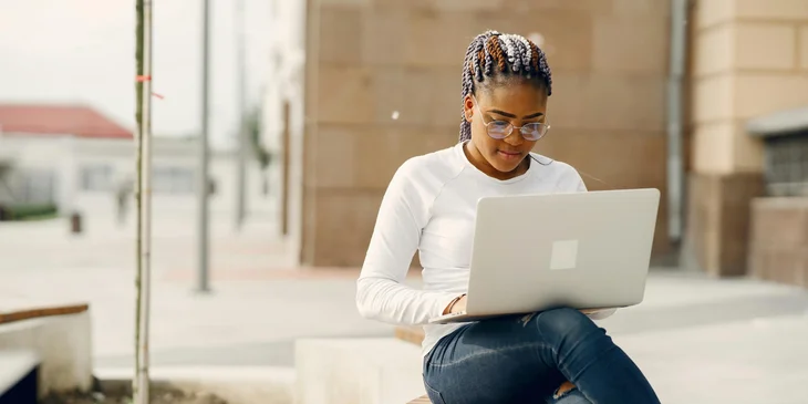 A woman working on her laptop.