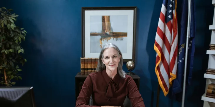 A professional woman sitting in a government office.