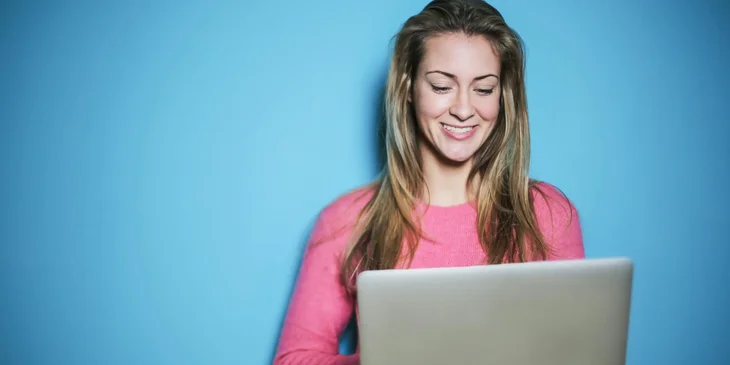 A woman working on her laptop in hand.