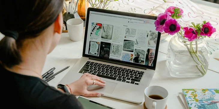 A graphic designer creating digital media based on the client's preferences.