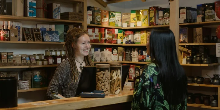 A grocery cashier assisting a woman.