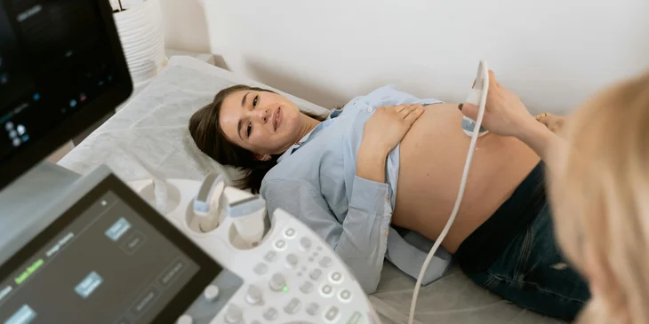 A gynecologist performing an ultrasound on a first-time mom.