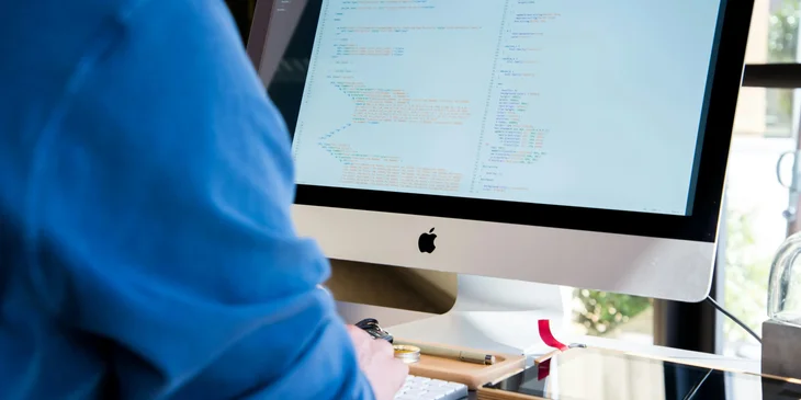 A Hadoop developer working on an application at his workstation.