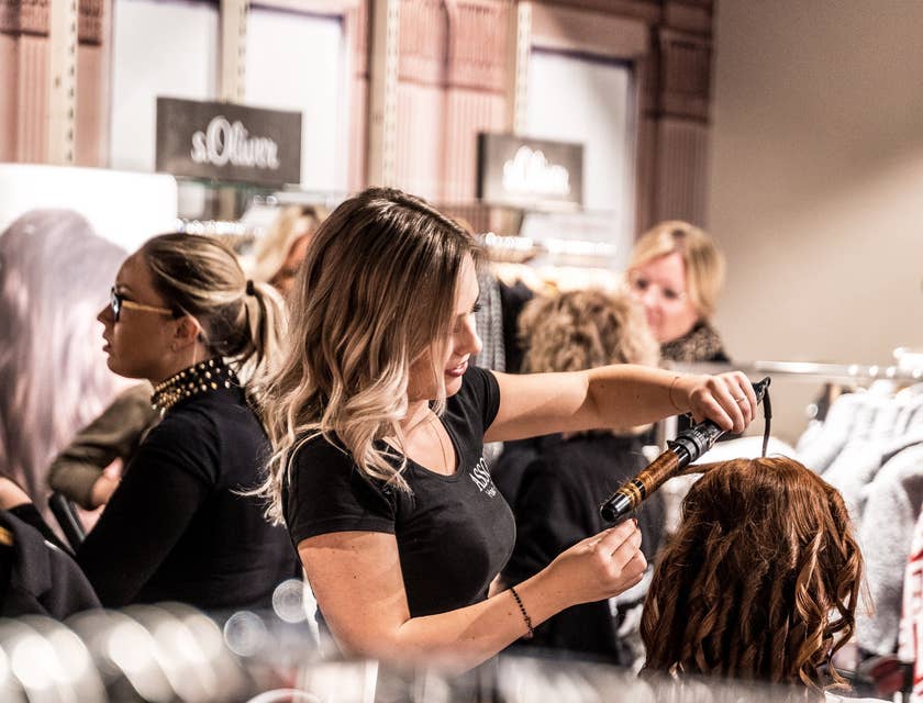 hair stylist curling a clients hair