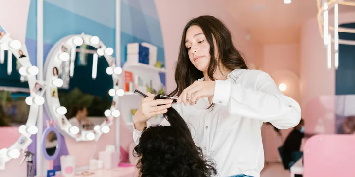 A hairdresser styling a client's hair.