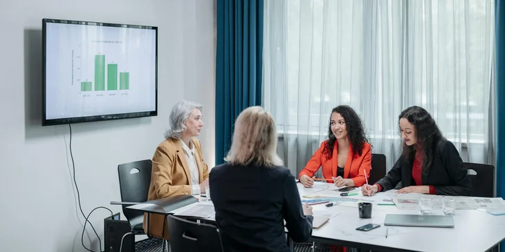 A female head of operations holding a meeting with the team.