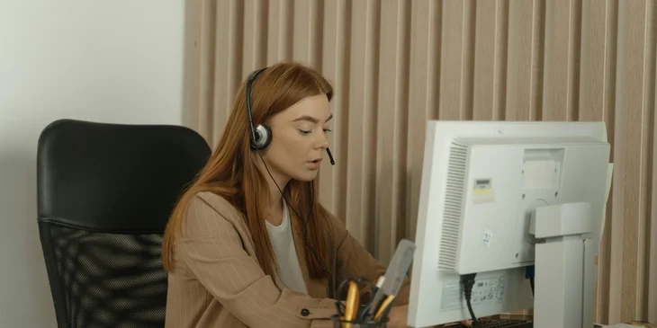 A healthcare customer service representative greeting customers with the suggested script.