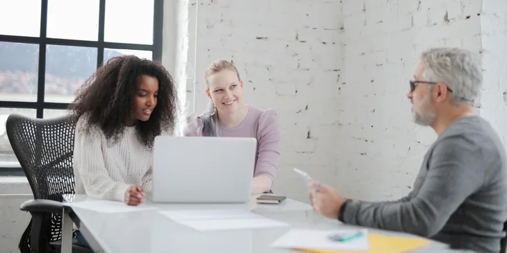 A health coach discussing with his team during a meeting.
