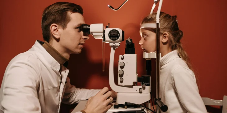 An optometrist examining a patient.