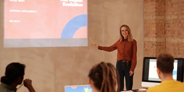 A teacher presenting her lesson using a projector.