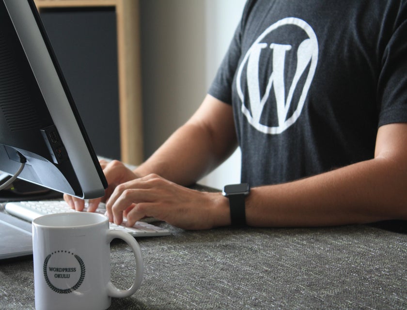 Person working on a computer wearing WordPress t-shirt.