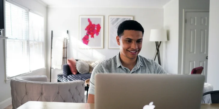 A man using his laptop at home.