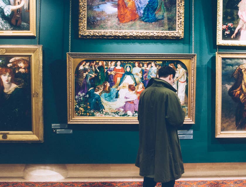History Teacher looks at painting as he prepares a new lesson plan about art history