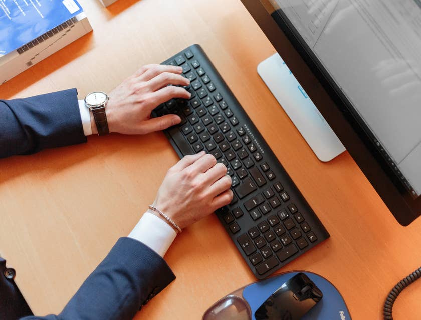 A man typing on a laptop.