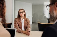 Um candidato sendo entrevistado por dois funcionários.