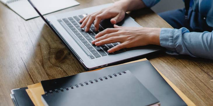 A person creating an interview process on a laptop.