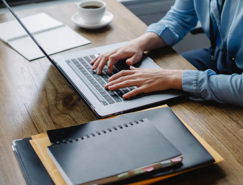 A person creating an interview process on a laptop.