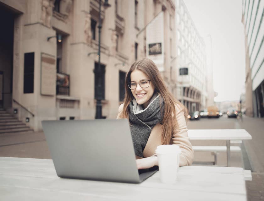 A woman typing on a laptop.