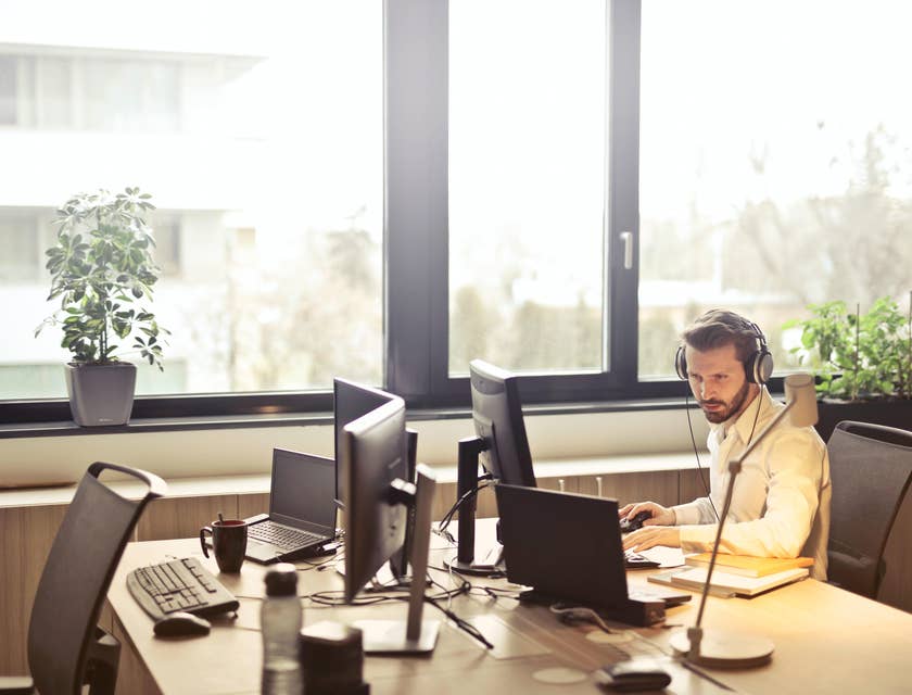 Man in an office doing remote interviews.
