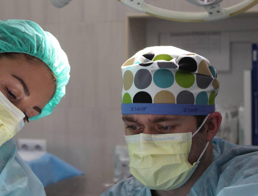 surgeon with nursing assistant