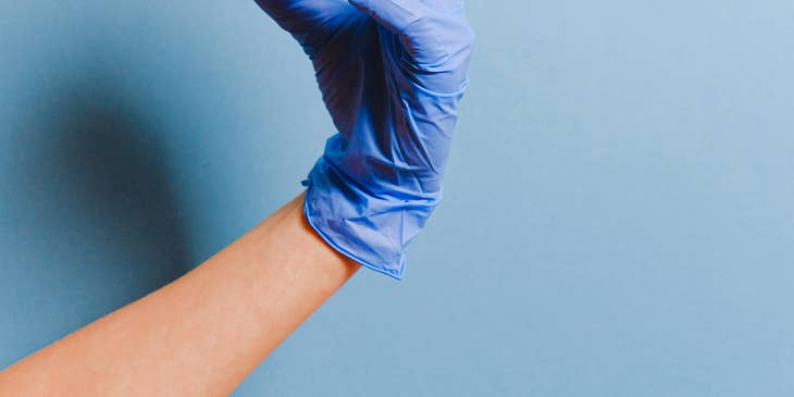 A PACU nurse holding a syringe.