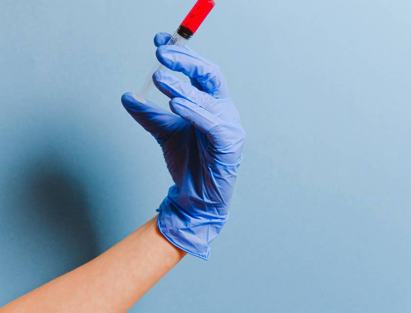 A PACU nurse holding a syringe.