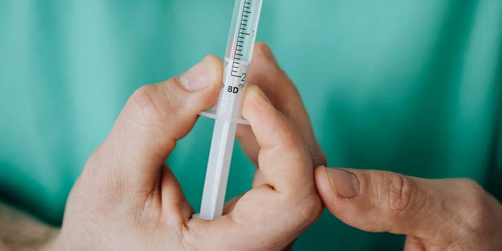 A nurse holding a syringe.